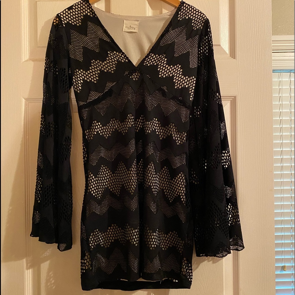 Black lace mini w/tan under long flowing sleeves.